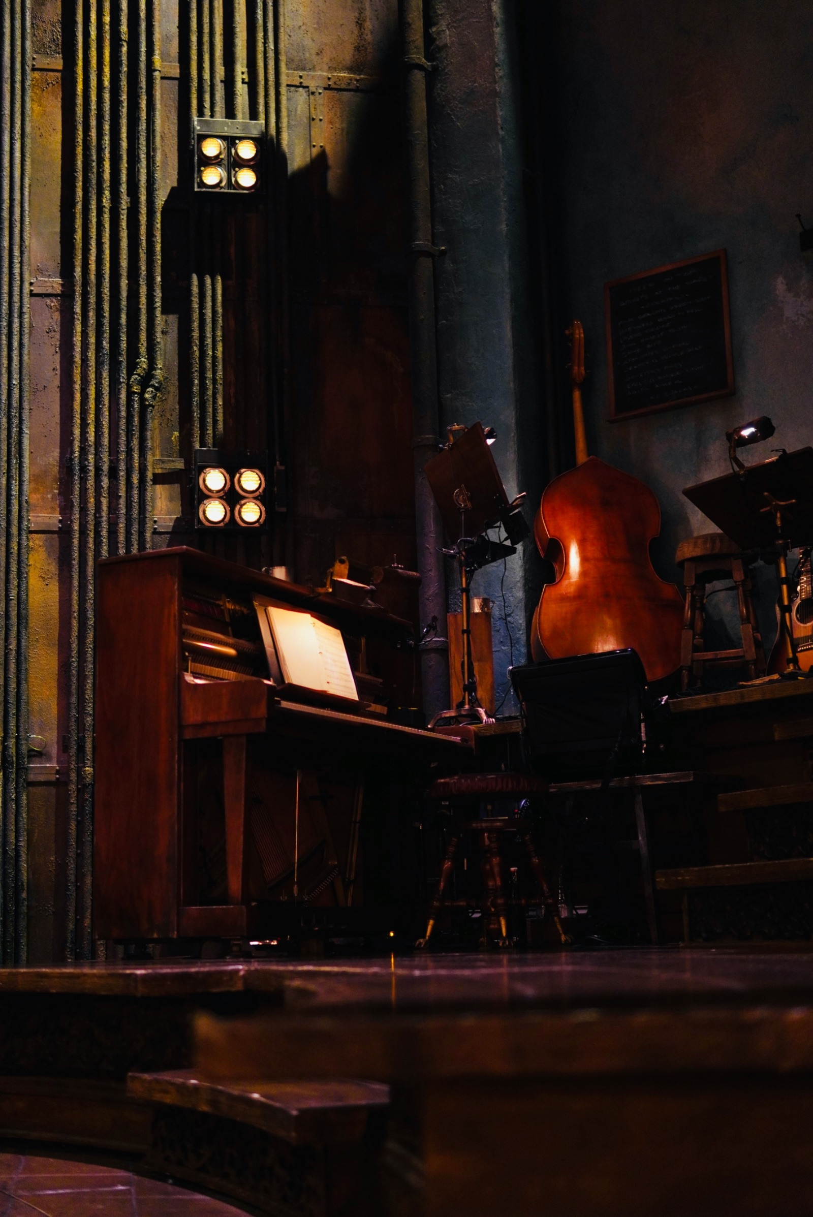 Upright piano and double bass on a theatre stage