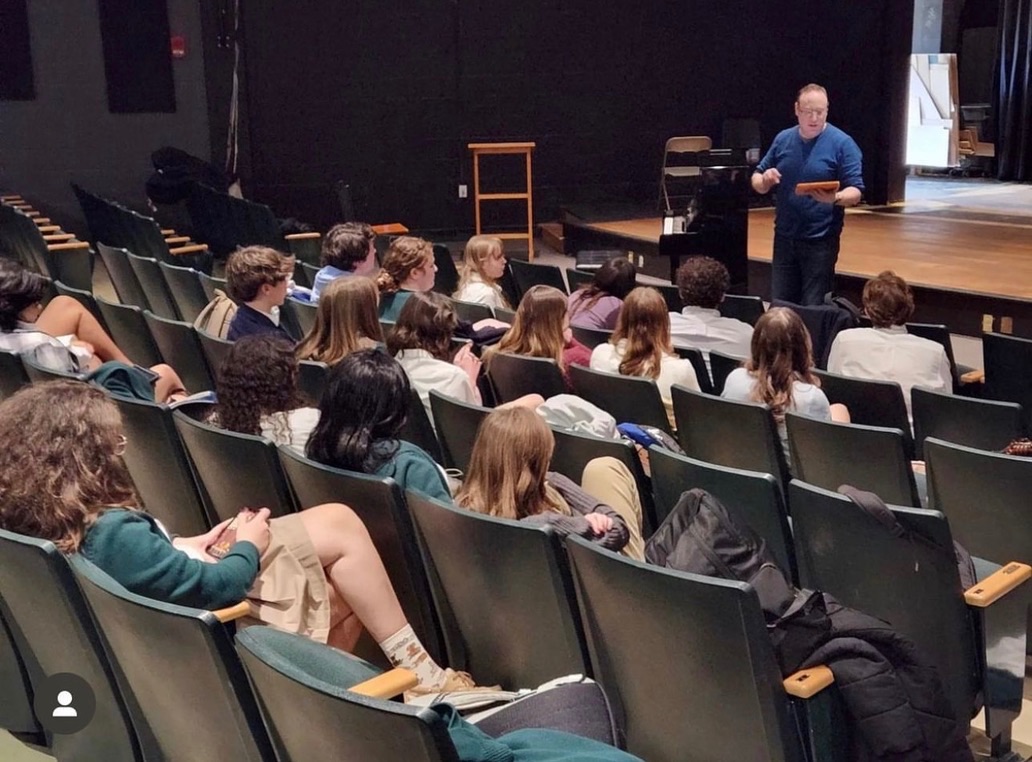 Brett Boles teaching students in a theatre